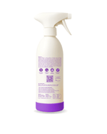 Spraying hard water stain remover on toilet bowl stains