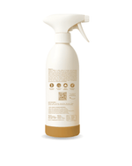 User spraying kitchen surface cleaner on cutting board area